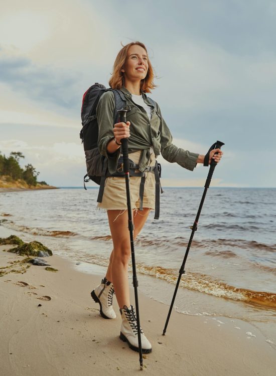 optimistic-traveller-using-walking-poles-during-beach-stroll-1.jpg